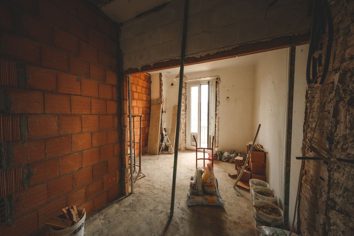 Reception room stripped back to brick and joists before work